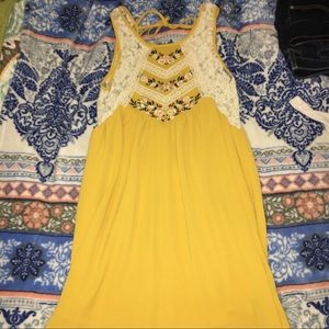 Yellow dress with flower decals and lace.